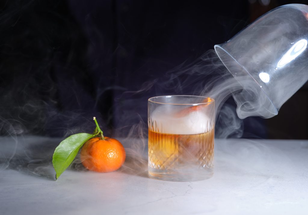 One of our alcoholic beverages, featured next to an orange