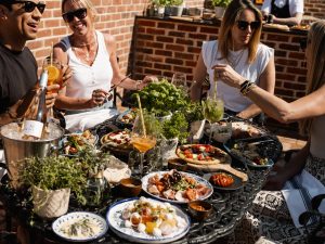 People sat round a table eating garden menu at Stanwell House